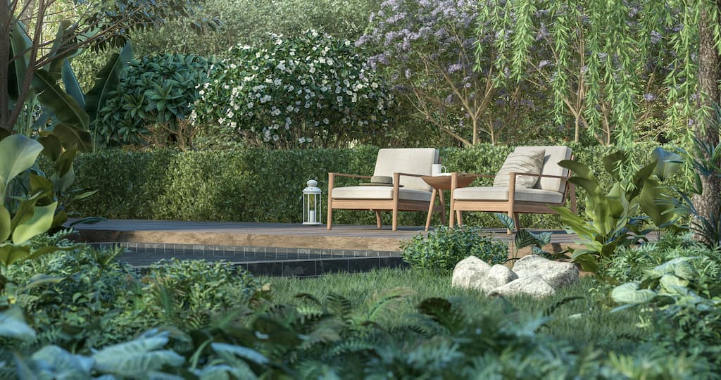 Comfortable armchairs with side tables in a green garden