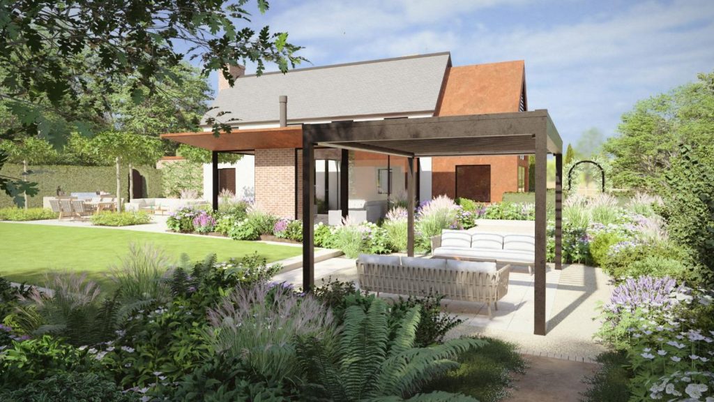Image of a garden with house in the background. A modern louvred pergola is in the mid ground and underneath this are comfortable sofas and a fire pit. There is an abundance of planting which creates a softness to the image. Part of a lawn can also be seen to the left of the image.